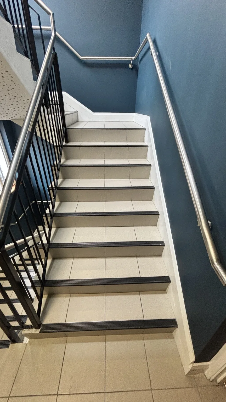 Clean communal tiled stairwell after Harbourlight cleaning